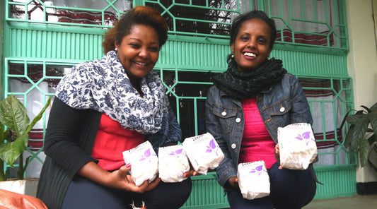 Two women holding Veeda pads