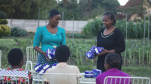 Woman giving pads to Women