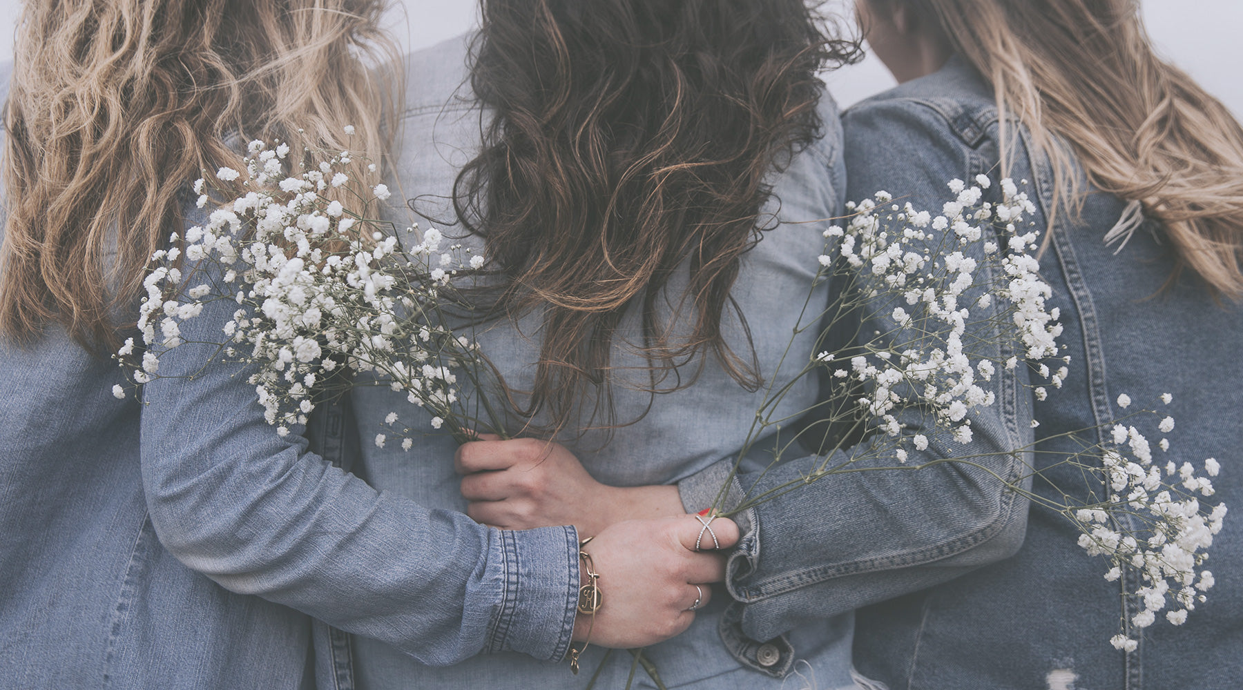 Women hugging and holding flowers