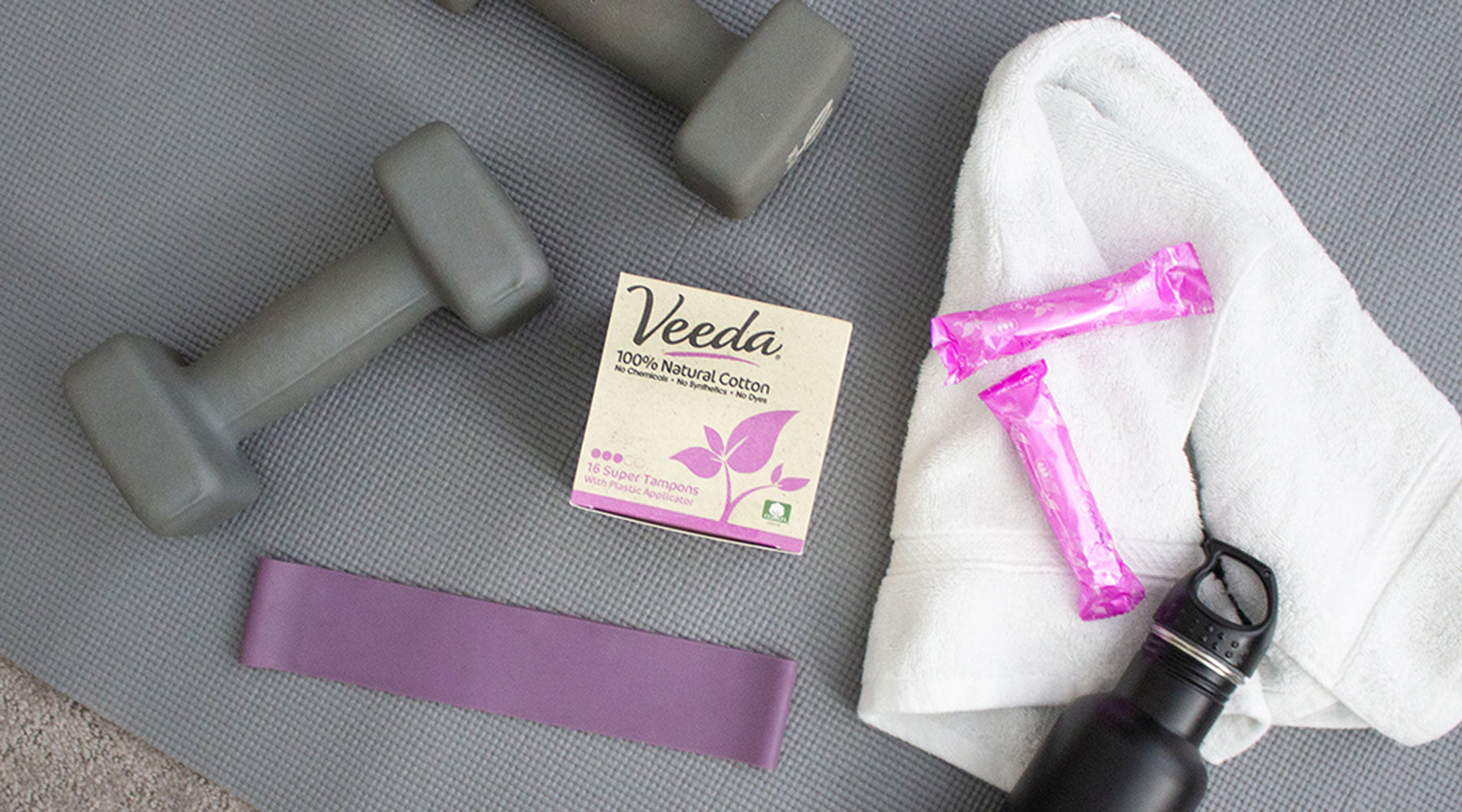 Veeda tampons on yoga mat and workout gear