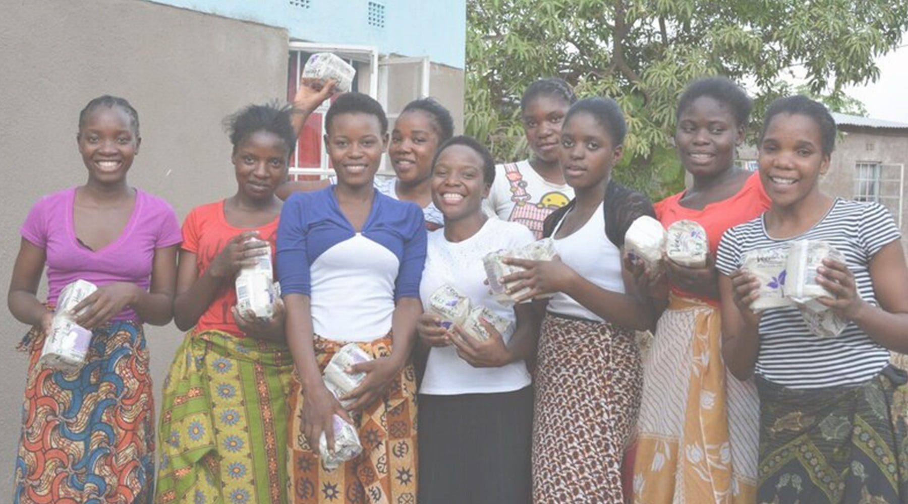Group of women smiling and holding feminine pads